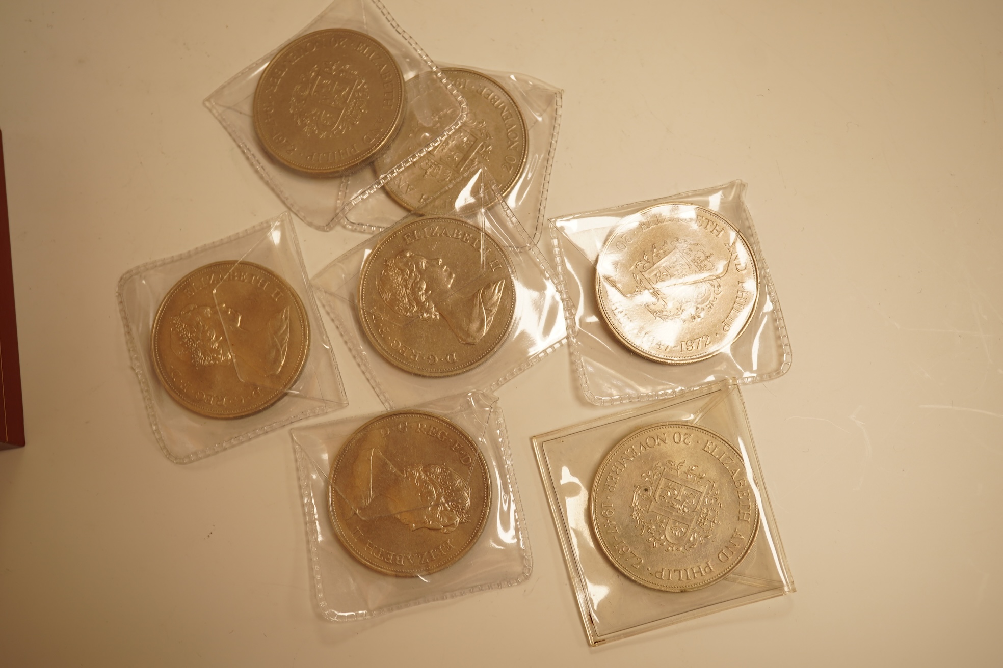 A collection of coins, notes and wrist watches